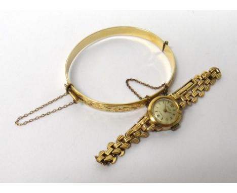 A lady's 9ct gold Accurist bracelet wristwatch, with a foldover clasp, with an Accurist case and a gilt metal oval hinged ban