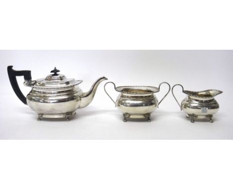 A silver three piece tea set, comprising; a teapot, a twin handled sugar bowl and a milk jug, each piece of compressed oval f