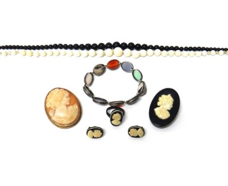 A single row necklace of graduated pale opal beads, a single row necklace of black beads, a 9ct gold mounted oval shell cameo