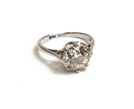 A white gold and platinum, diamond set single stone ring, mounted with a cushion shaped diamond, ring size G and a half, the 