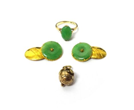 A pair of gold and jade set cufflinks, each with a circular jade front and with an oval gold back, with engraved decoration, 