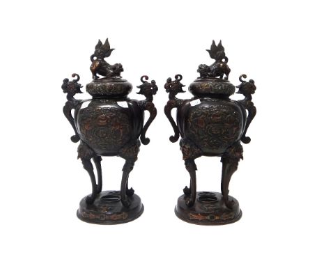 A pair of Japanese bronze two-handled koros and covers, Meiji period, the lobe globular bodies cast each side with birds amon