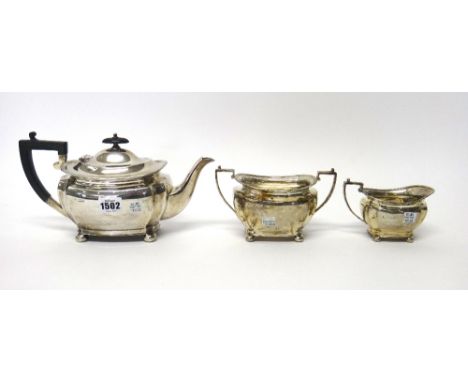 A silver three piece tea set, comprising; a teapot, a twin handled sugar bowl and a milk jug, each piece of curved panelled f