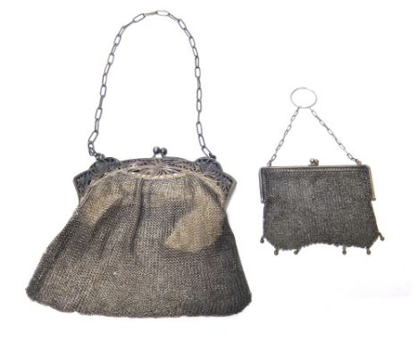 A Sterling mounted lady's chain mesh evening bag, the mount with pierced and engraved floral decoration and with an oval link
