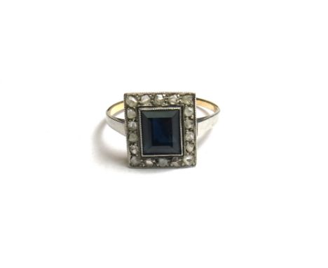 A gold, sapphire and diamond set rectangular cluster ring, mounted with the rectangular step cut sapphire at the centre, with