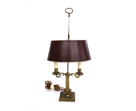 A brass bouillotte lamp, early 20th century, with twin sconces and adjustable rouge oval tin shade on a square stepped base. 