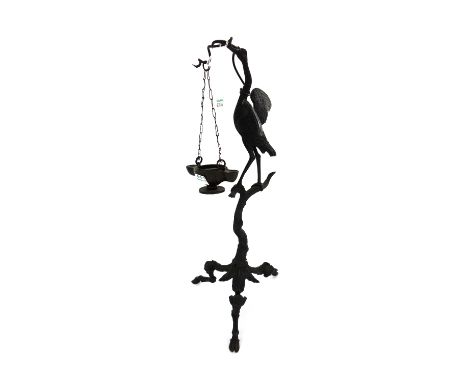 A pair of Continental Italian bronze oil lamps, 20th century, each moulded and cast with a crane holding an oil lamp suspende