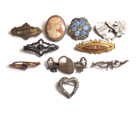A 9ct gold and half pearl set bar brooch, in an elliptical design, with a beaded and wirework border, Birmingham 1908, a gold