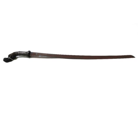 A South East Asian sword, late 19th century, with slightly curved single edged steel blade (70cm), silver foliate cast handle