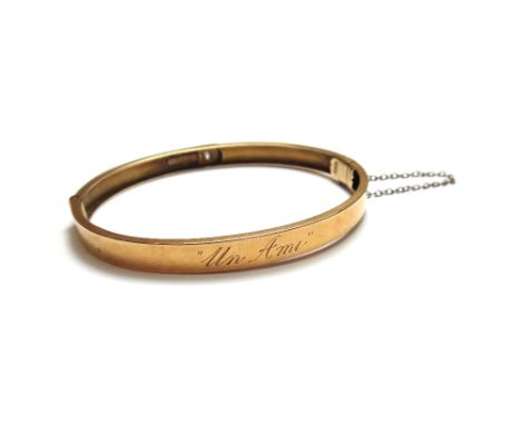 A gold and diamond set single stone oval hinged bangle, star gypsy set with a cushion shaped diamond, on a snap clasp detaile