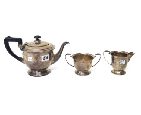 A silver three piece tea set, comprising; a teapot, a twin handled sugar bowl and a milk jug, each piece of circular form, th