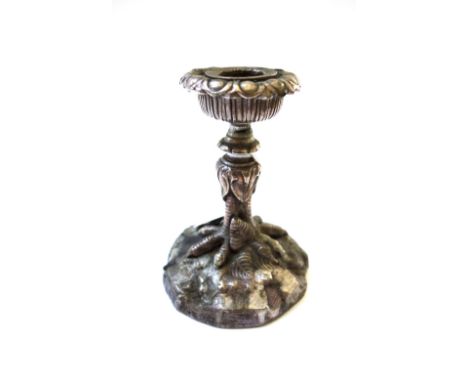A silvered bronze candlestick, 20th century, modelled and cast with foliate sconce over a 'birds foot' stem and naturalistic 