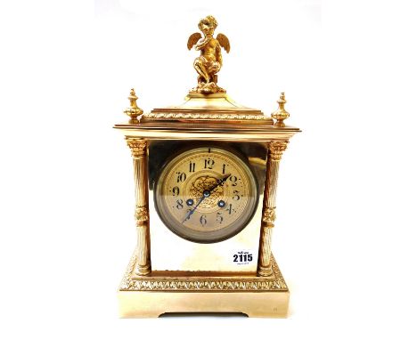 A French gilt brass cased mantel clock, late 19th century, with angel finial over a gilt engine turned dial, flanked by pilla