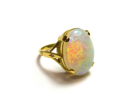 An 18ct gold ring, claw set with an oval opal, ring size N, with a case.