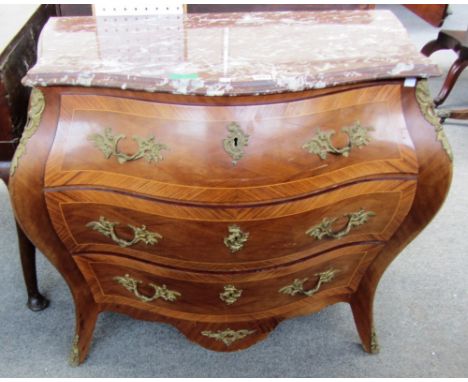 An 18th century style gilt metal mounted kingwood banded mahogany marble topped bombe three drawer commode on splayed feet, 9