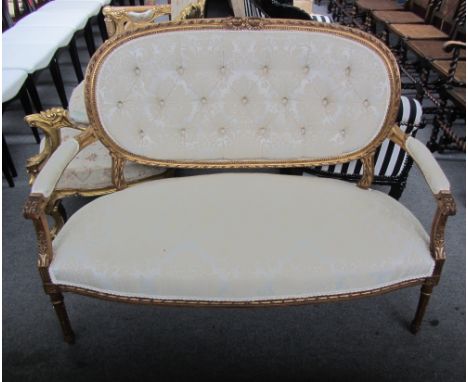 A Louis XVI style gilt framed open arm sofa, on tapering fluted supports, 127cm wide.