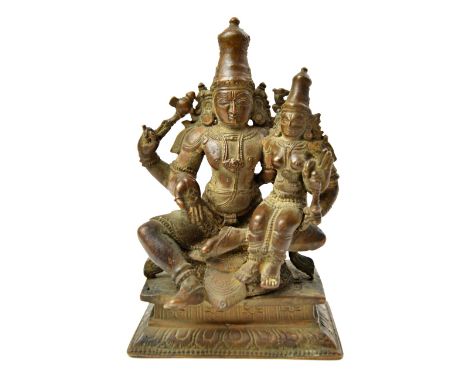 A bronze group of Shiva and Parvati, South India, 19th century, Shiva seated in lalitasana with right hand in vadra mudra, ho