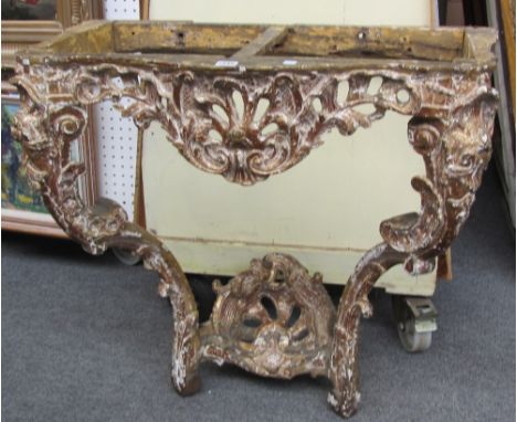 A late 18th century carved giltwood console table base with shell carved frieze and pair of scroll supports, 83cm wide.