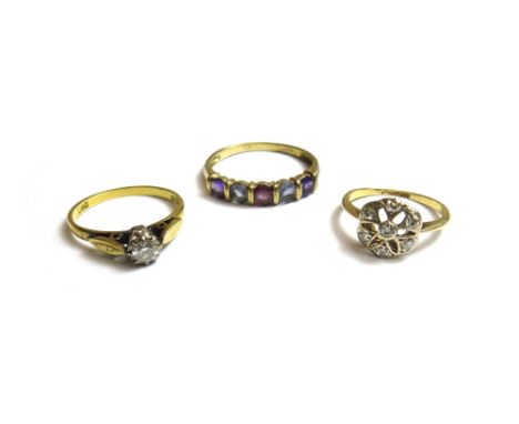 An 18ct gold and diamond set single stone ring, claw set with a circular cut diamond, a gold and diamond set seven stone clus