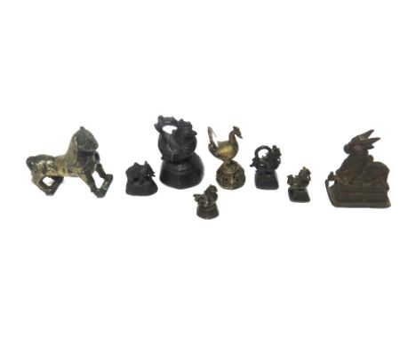 A group of four Burmese bronze duck and animal opium weights, 19th century, largest 12cm.high; also a small bronze elephant w