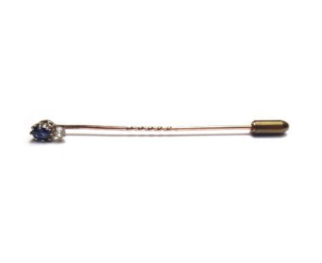 A gold, sapphire and diamond set stick pin, claw set with an oval cut sapphire above a smaller cushion shaped diamond.