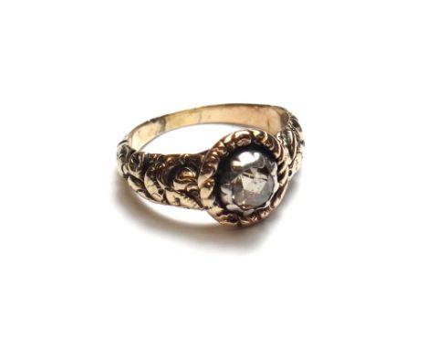 A rose diamond set single stone ring, mounted with a single rose diamond to the centre, the shoulders with floral and foliate