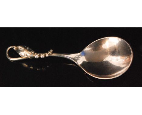 A Danish Sterling silver caddy spoon by Georg Jensen in the blossom pattern, design number 84, with hammered circular bowl be