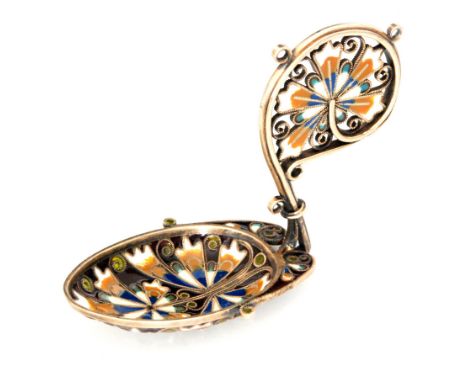 An early 20th Century plique a jour enamelled gilt metal caddy spoon, the bowl detailed with a butterfly and flower in blues,