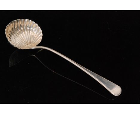 A George III hallmarked silver Old English pattern ladle with shell bowl below feather edged decoration to handle, length 33c