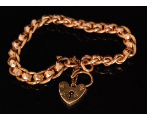 An early 20th Century 9ct rose gold curb and roller link bracelet, terminating in padlock fastener, total weight 19g. 