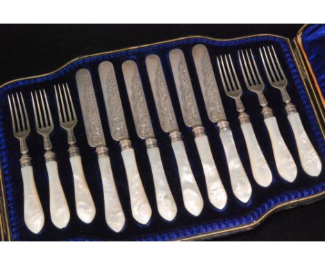 A Victorian hallmarked silver fruit set composed of six mother of pearl and silver foliate engraved fruit knives and forks co