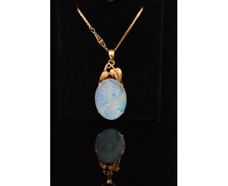 An oval opal doublet pendant within a leaf mounted frame to fancy link chain, unmarked