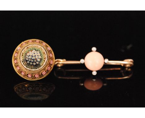 An early 20th Century 9ct bar brooch set with central cabachon cut coral within a four stone diamond surround, length 4cm, to