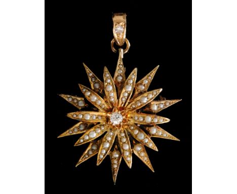 An early 20th Century gold seed pearl and diamond set star pendant, central claw set diamond within seed pearl set radiating 