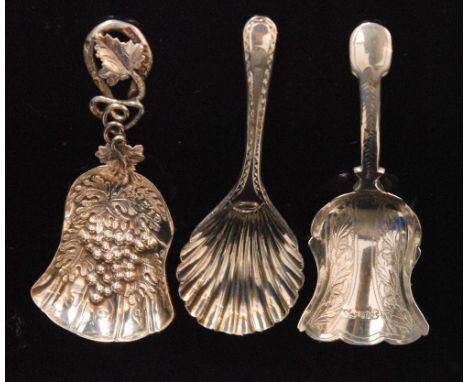 A Victorian hallmarked silver caddy spoon of naturalistic design, the die stamped shovel shaped bowl with fruit grape and vin