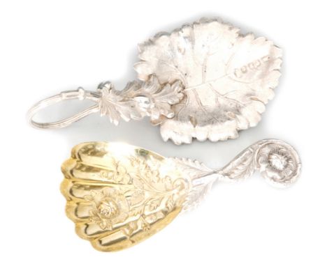 A Victorian hallmarked silver caddy spoon with gilded and fluted bowl with floral and thistle head decoration and twisted lea