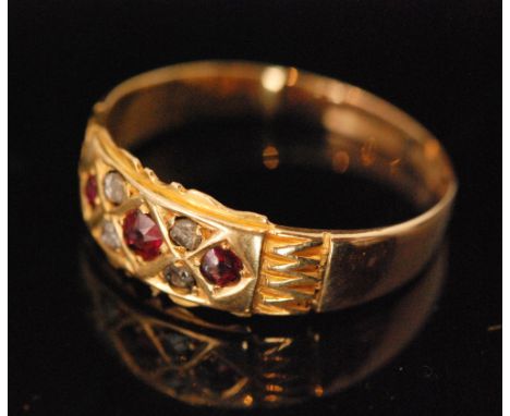 A Victorian 18ct hallmarked ruby and diamond boat shaped ring, three central rubies spaced by four rose cut diamonds, Chester