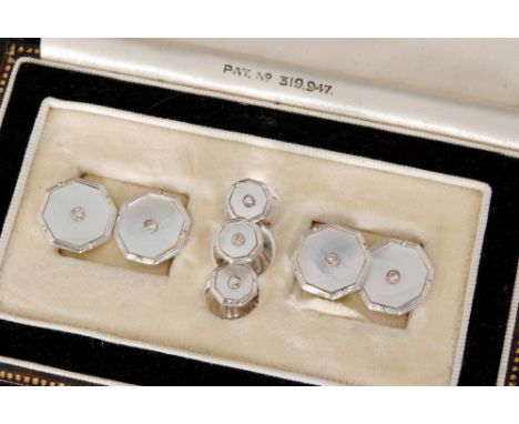 A set of Art Deco style 9ct white gold and mother of pearl cufflinks and studs, each of octagonal outline, with diamond set c