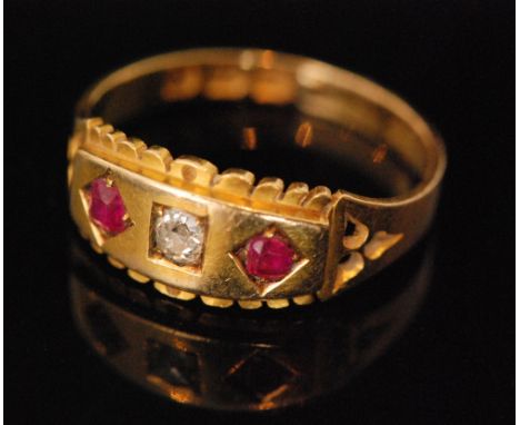 A late 19th Century 18ct ruby and diamond, gypsy set three stone boat shaped ring, central diamond flanked by rubies, ring si