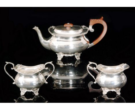 An Elizabeth II hallmarked silver three piece tea service composed of teapot, sugar bowl and cream jug, each with egg and dar