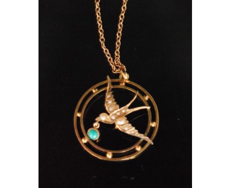 An Edwardian 9ct circular open work pendant modelled as a seed pearl swallow in flight with single turquoise stone, all suspe