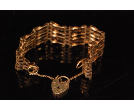 A modern 9ct six bar gate bracelet terminating in padlock fastener, weight 14g. 