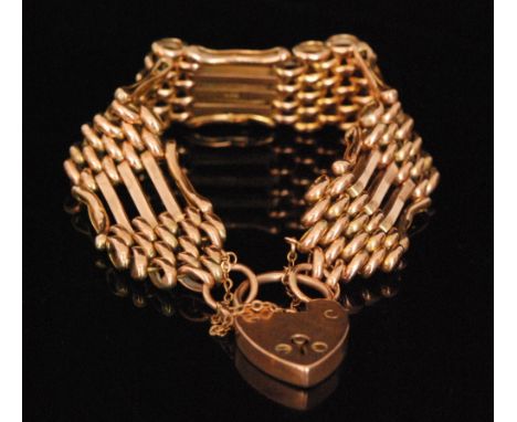 A late 19th Century 9ct rose gold five bar gate bracelet terminating in padlock fastener, weight 21g. 