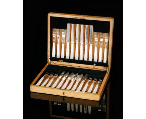 An oak cased set of twelve Art Deco hallmarked silver and mother of pearl handled fruit knives and forks, Sheffield 1938, Map