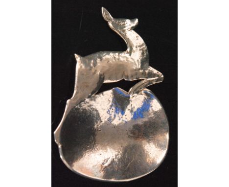 An Arts and Crafts hallmarked silver 'Leaping Deer' caddy spoon, the hammered and shaped bowl beneath a leaping deer handle, 