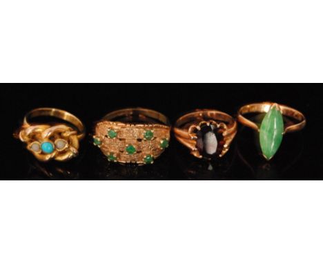 Four 20th Century 9ct stone set rings to include a single jade ring, a seven stone emerald example etc. (4). 