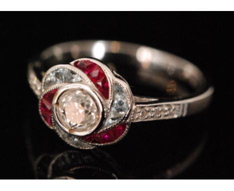 An 18ct white gold an aquamarine, diamond and ruby ring, central old cut diamond, weight approximately .40ct, within an alter