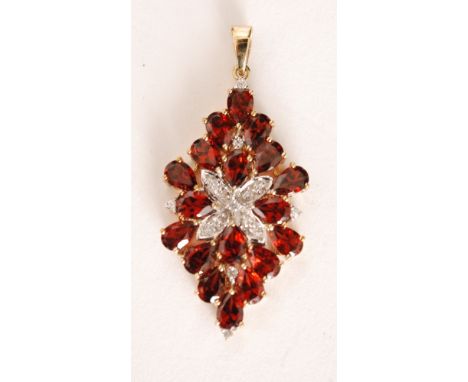 A 9ct hallmarked garnet and diamond pendant, central pave diamond set cross within an eighteen stone pear shaped, claw set ga