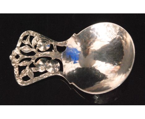 An Arts and Crafts hallmarked silver caddy spoon, the hammered circular bowl below  a pierced handle with fruiting apple tree