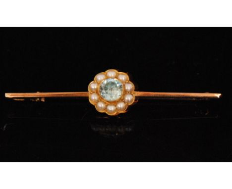 An aquamarine and split pearl flower head bar brooch, the rose gold bar centred by collar set brilliant cut aquamarine within